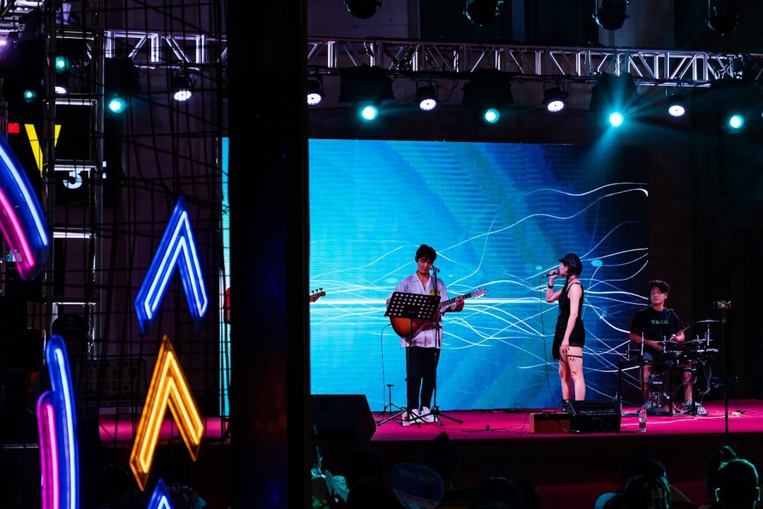 Musician performing on stage with concert lights